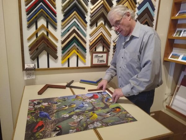 Norm Brovelli working on framing a picture