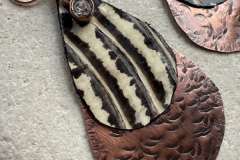 Earrings of copper with snakeskin-and Swarovski crystals, by Judy Dailey