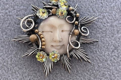 Necklace of carved moon bone in Sterling silver with Swarovski flowers, by Judy Dailey