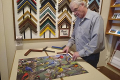 Norm Brovelli working on framing a picture
